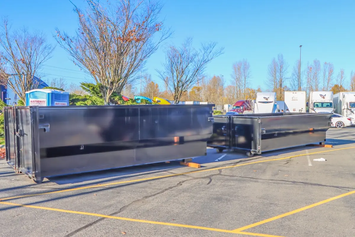 Professional dumpster rental service with roll-off container on residential driveway in Twin Falls